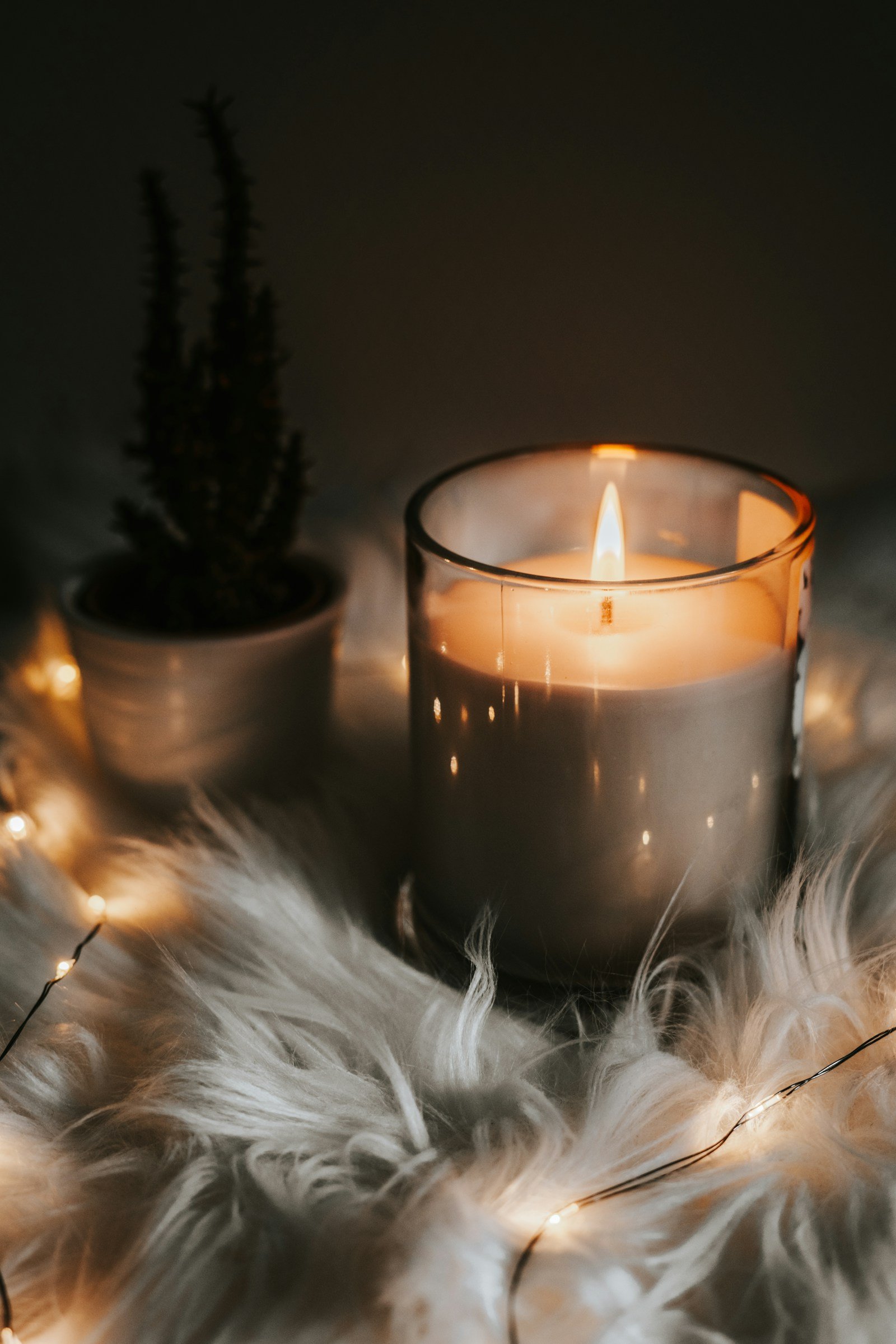 A warm candle glowing in a cozy room